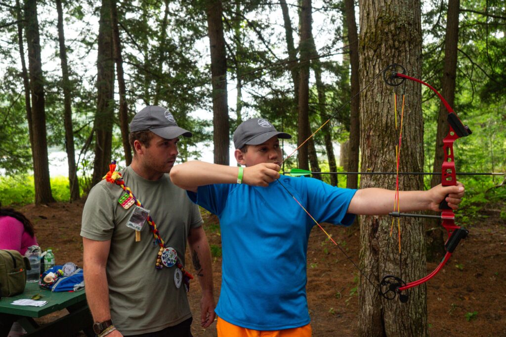 ollie art archery with volunteer