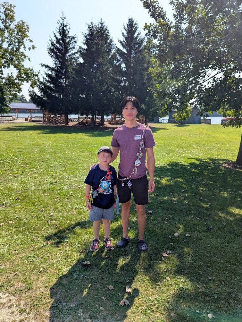 ben with counsellor outside at camp