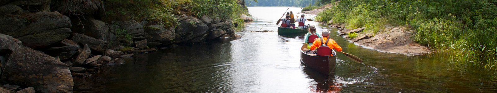 campers in canoes on the lake