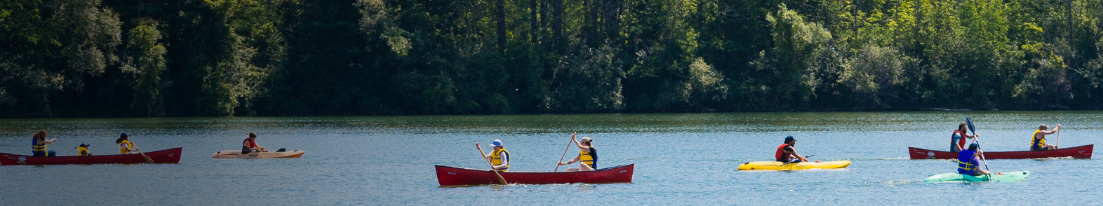 campers in canoes on the lake
