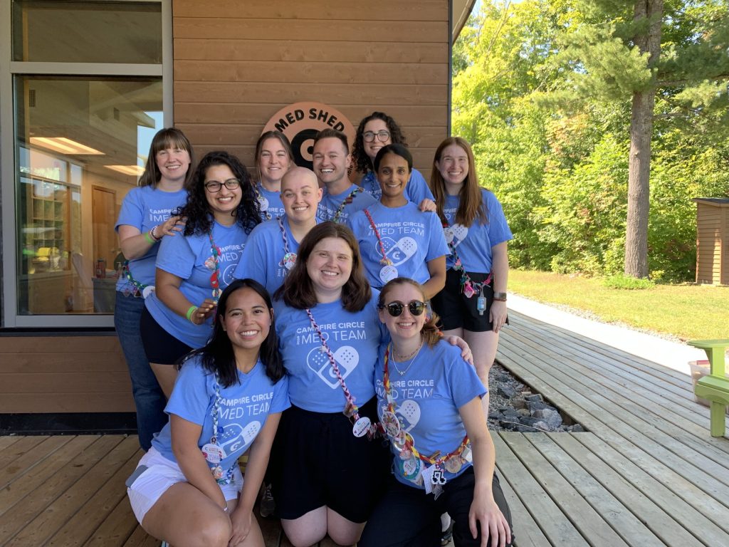 armita and the med team in front of the med shed at camp