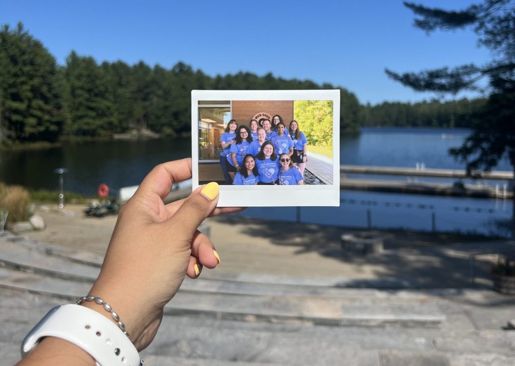 armita holding out a polaroid of the med team